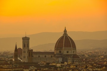Fototapeta na wymiar Cathedral of Santa Maria del Fiore (Duomo). Amazing evening golden hour light. View from Piazzale Michelangelo. Beautiful gold sunset in Florence, Italy.
