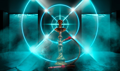 Hookah with smoke on the background of a concrete pavement with multi-colored laser beams, neon light, smoke