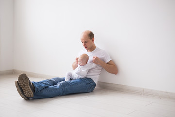 Fatherhood, parenthood and baby concept - Bald father having fun with his little infant daughter