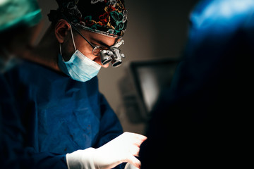 Portrait of surgeon performing in operation theatre. Close up portrait of surgical doctor...