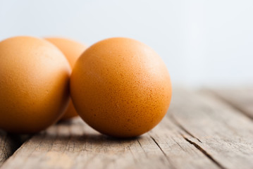 three eggs on weathered wooden table