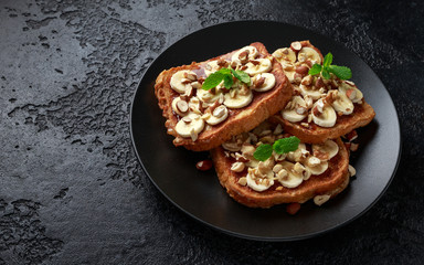 French cinnamon toast with banana, nuts and hazelnut, honey.
