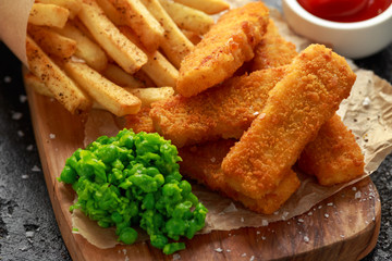 Fish fingers, mashed peas and chips fries. Traditional British fast food.