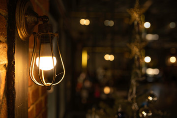 Antique electronic lamp, hanging at the red brick wall in the building.soft focus.