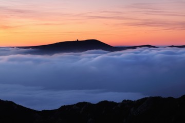 Beautiful sunset on the highest peak and colorful golden red sky, Krkonose (Giant Mountains), Czech...