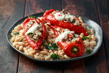 Stuffed pointed bell peppers with mince and basmati rice served with cannellini beans and chilli