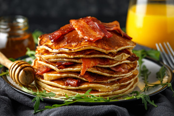 Pancakes with crispy bacon and maple syrup in a plate. Morning Breakfast