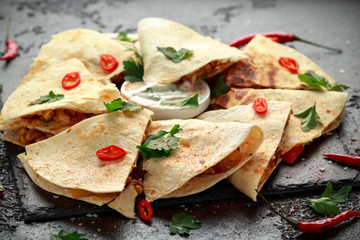 Mexican quesadilla with chicken, cheese and peppers, yogurt dip and chilli.