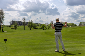 Man golfer posing at fairway on golf course
