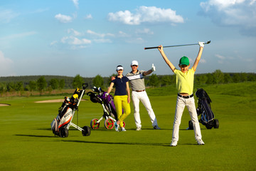 The boy with his family playing golf