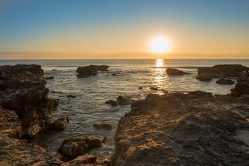 A sunrise between the rocks of Oropesa del Mar