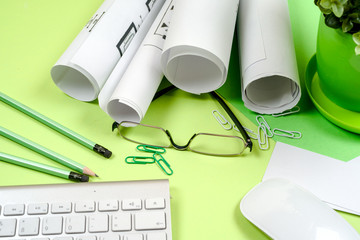Workplace of architect - rolls and plans. Construction background.