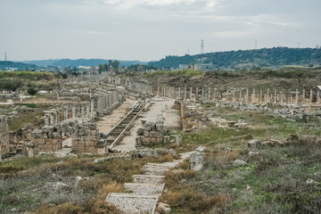 Fototapeta na wymiar Historical site of Perge or Perga in Antalya, Turkey. Vast remains of prosperous Roman city. Ancient Perge city existed from X century before Christ till VIII of our era. Aerial top view.