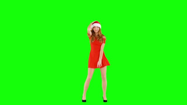 Attractive Female Wearing Red Dress and Christmas Hat Dancing on Green Screen