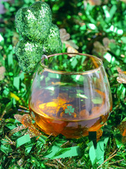 St Patricks Day Irish Whiskey Glass with Shamrock and TInsel Close up
