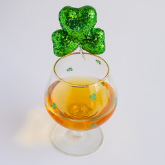 St Patricks Day Irish Whiskey Glass with Shamrock only in Focus