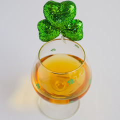 St Patricks Day Irish Whiskey Glass with Shamrock in Focus