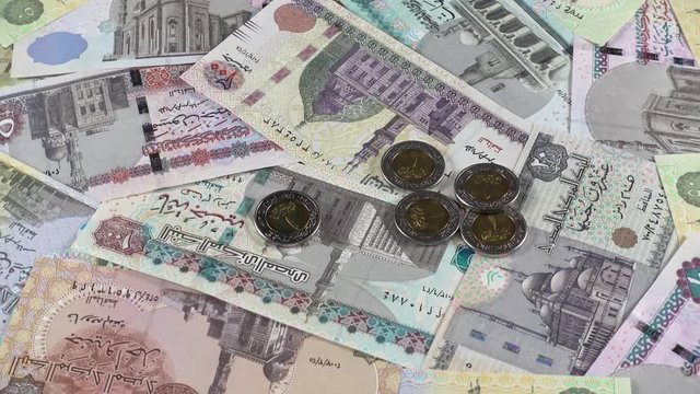 Egyptian pound bills and coins rotating. Egypt money currency. Low angle. 4K stock video footage