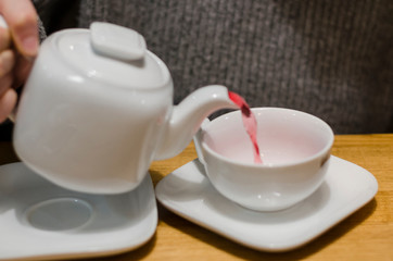 Pouring red tea into a cup