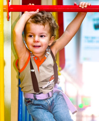 Funny cute happy baby playing on the playground. The emotion of happiness, fun, joy. Smile of a child.