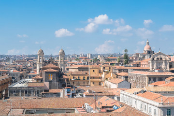 Fototapeta premium Aerial skyline panoramic view of Catania in September, old town featuring brown and yellow roofs with Mount Etna at background. Sicily, Italy 