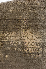 Historical site of Perge or Perga in Antalya, Turkey. Ancient text carved in wall. Vast remains of...
