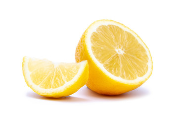 Fototapeta na wymiar Isolated half and slice of juicy yellow lemon on white background