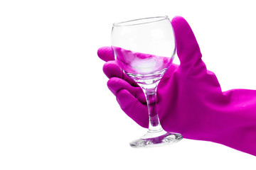 Housewife in rubber gloves is holding clean wine glass on a white background. Isolated. Hand protection from chemical detergent while washing and cleaning dishes