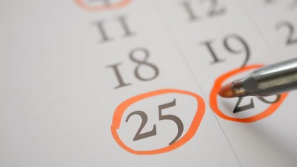 catholic christmas twenty fifth of december, Signing a day on a calendar by red pen