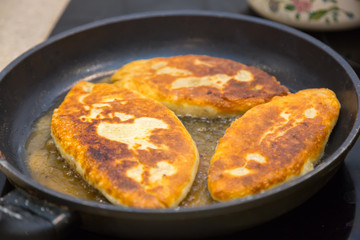 Homemade hot cakes pasty in a pan close-up. Kitchen