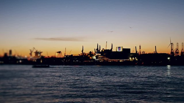 Wide angle lens over Hafen at dusk industrial pipes gas and oil factories in background