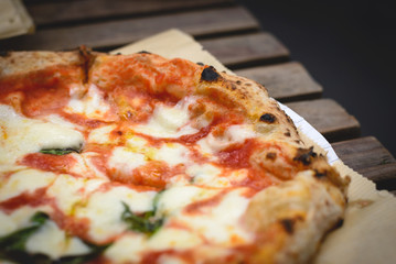 Close up view of a Margherita Neapolitan style pizza with buffalo mozzarella, tomato sauce and...