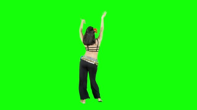 Full length of a pretty woman exercising a zumba dance in the studio. Shot in 4k resolution with green screen background