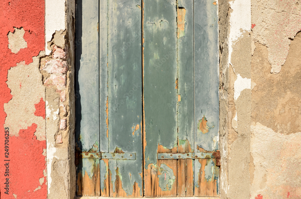 Wall mural Weathered wood. Cracked paint on a wooden wall. Grunge background. Weathered wood light green and orange