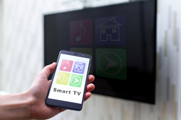 Online control TV by wifi using a mobile app on smartphone. Smart TV and home