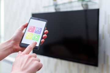Online control smart TV by wifi using a mobile app on smartphone. Smart home