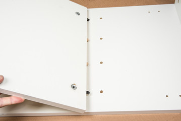 Handyman is assembling a cabinet. Furniture put together concept