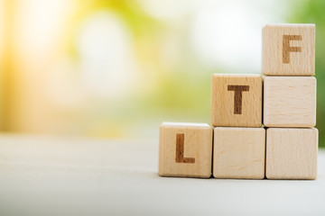 Obraz premium Wood block word LTF with copy space using as background business financial, saving money, retirement concept...