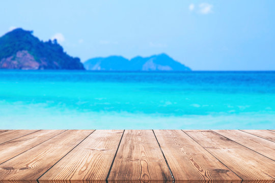 Wood table and beautiful sea with sand beach background