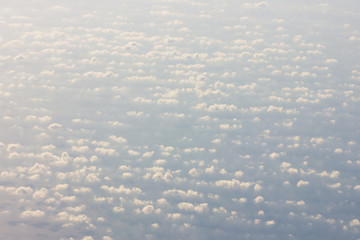Background blue sky with a cloud behind the airplane window