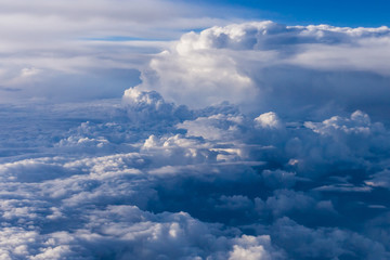 Fototapeta premium White clouds and blue sky from an airplane