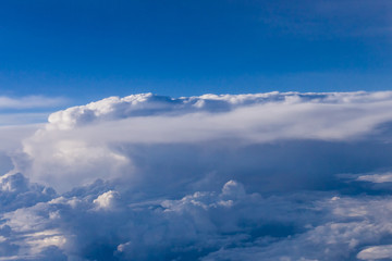 Fototapeta na wymiar White clouds and blue sky from an airplane
