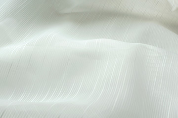 white cloth closeup. Smooth soft curves of the fabric. Can be used as background.