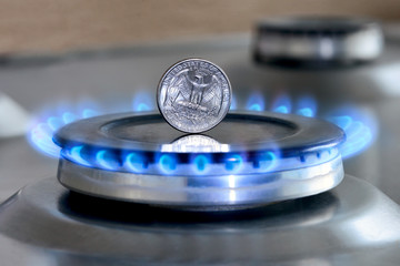 Gas hob with burning natural gas, quarter US dollar coin