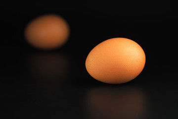 Brown egg on dark background