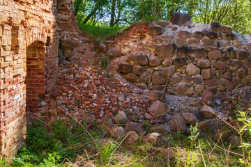 Destroyed old building of brick and stone in the forest