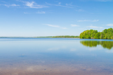Calm large lake in spring in clear weather