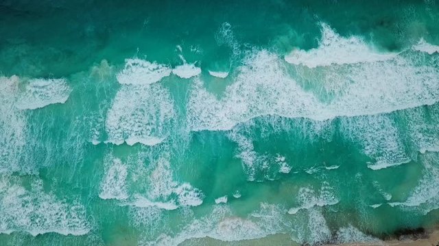 Aerial Tilt Down: Huge Wave Approaching Shorelines of Carmen Del Playa Beach