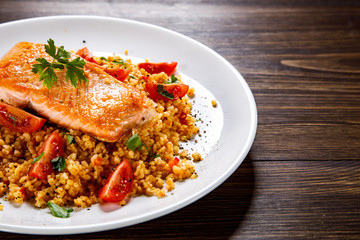 Roast salmon with groats and vegetables