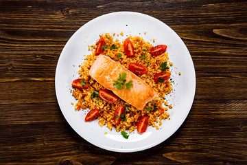 Roast salmon with groats and vegetables